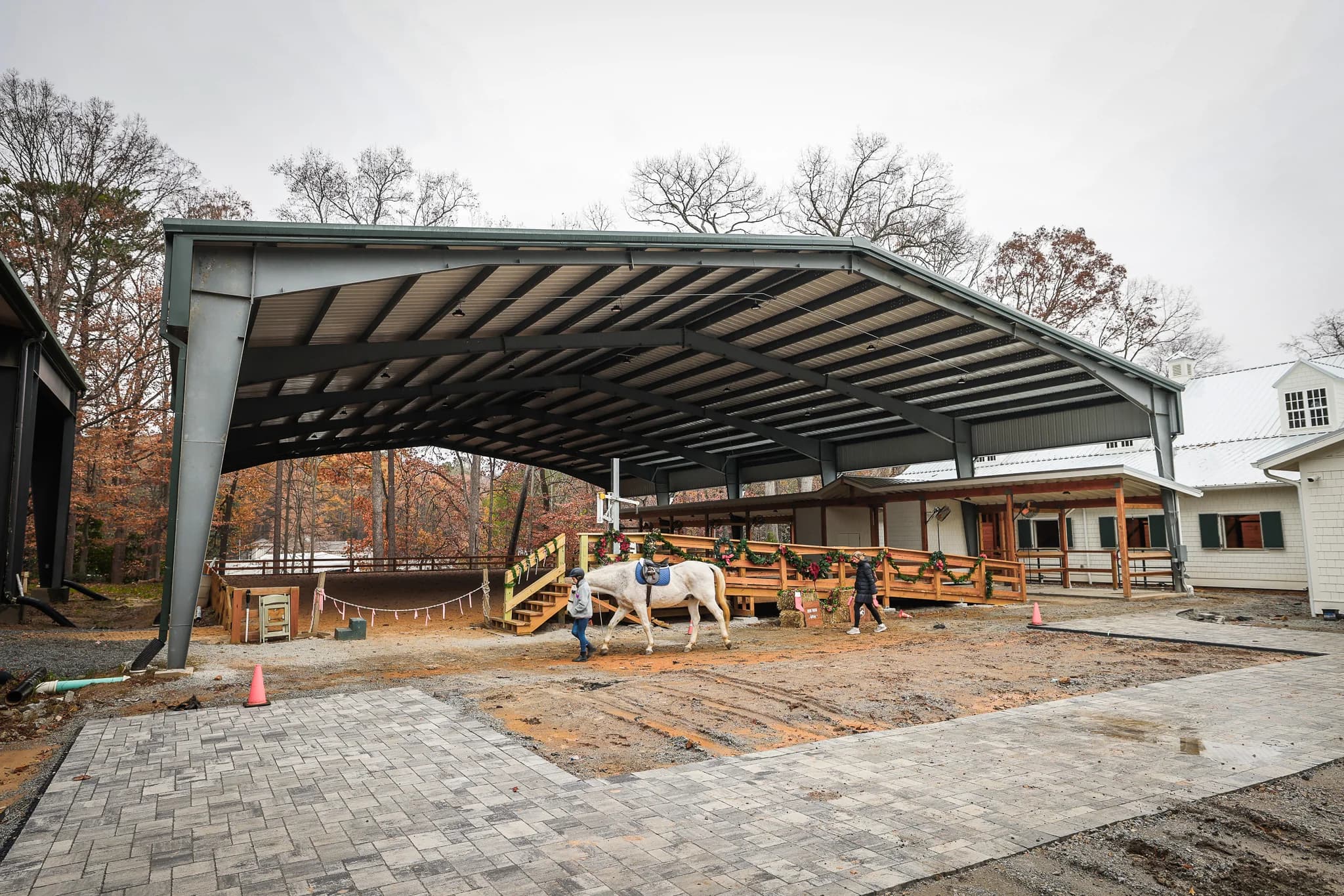 Horse being led under steel covered arena