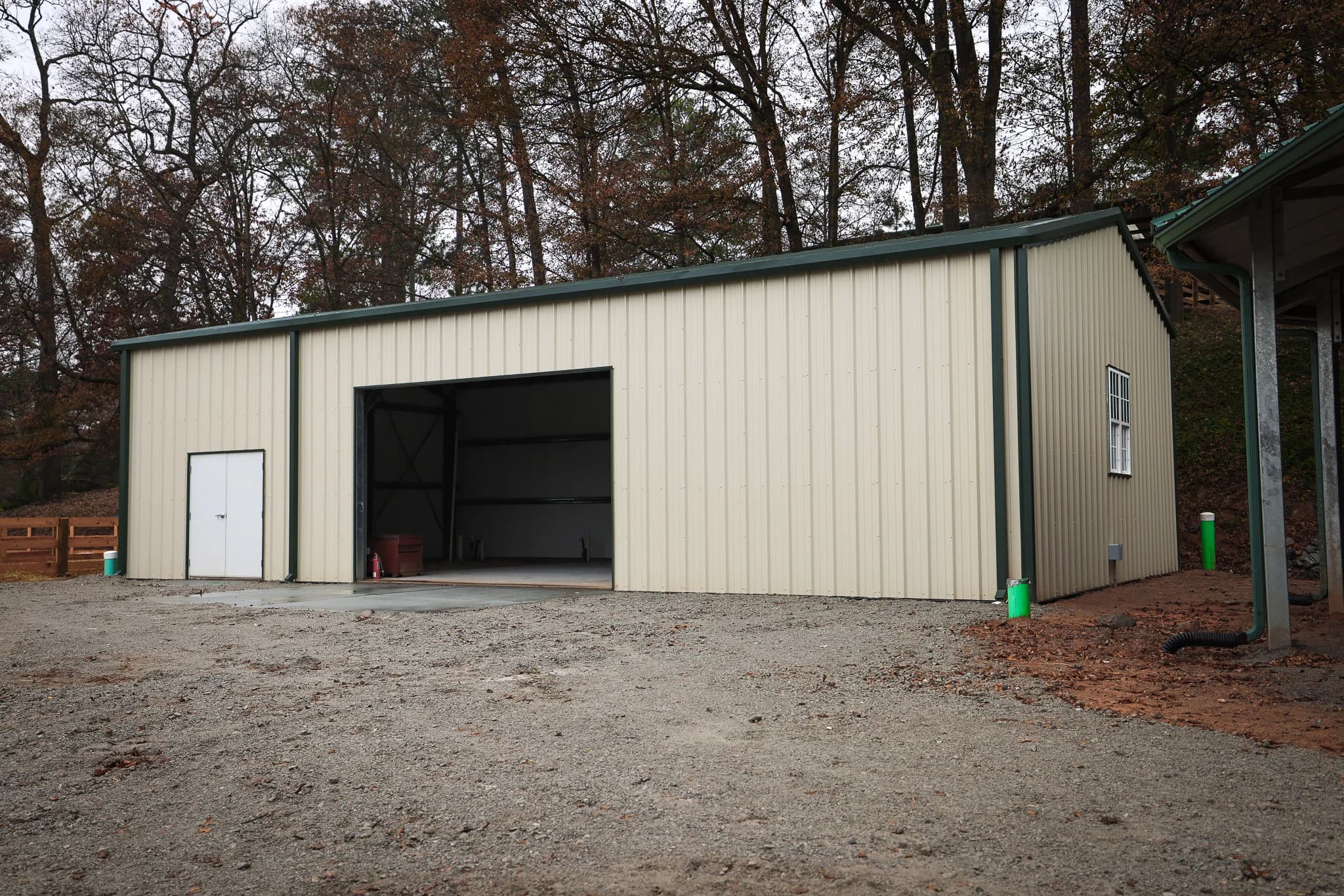 Steel equipment storage building with roll-up door