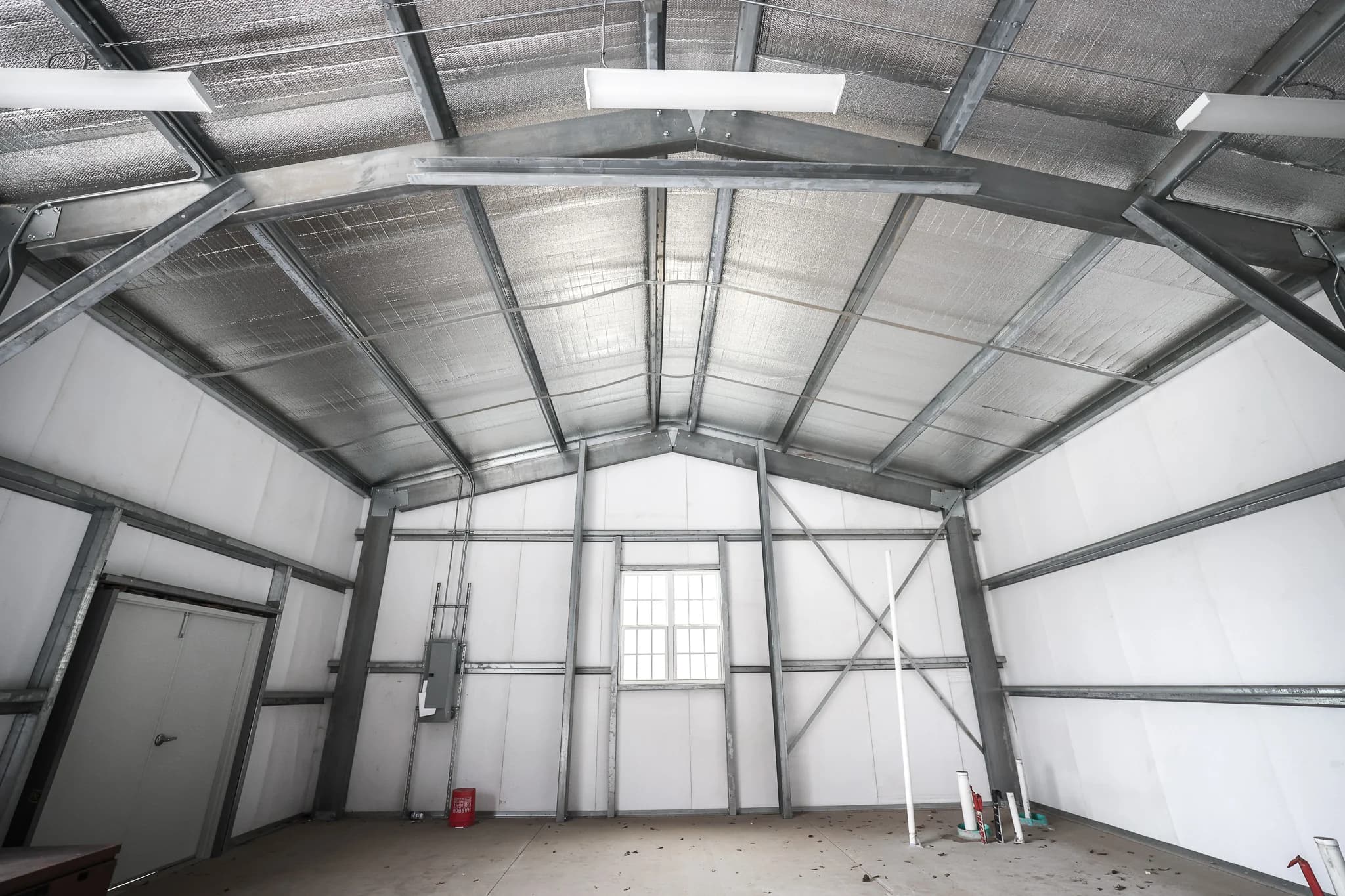 Clear-span steel building interior with insulated ceiling