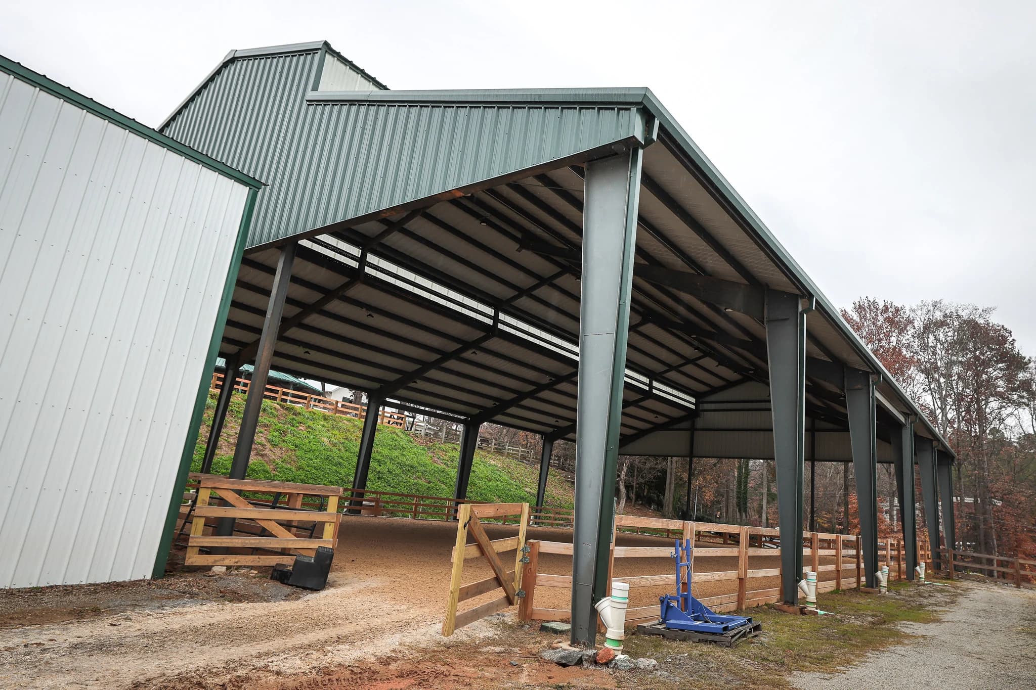 Steel covered arena side view showing clear-span structure