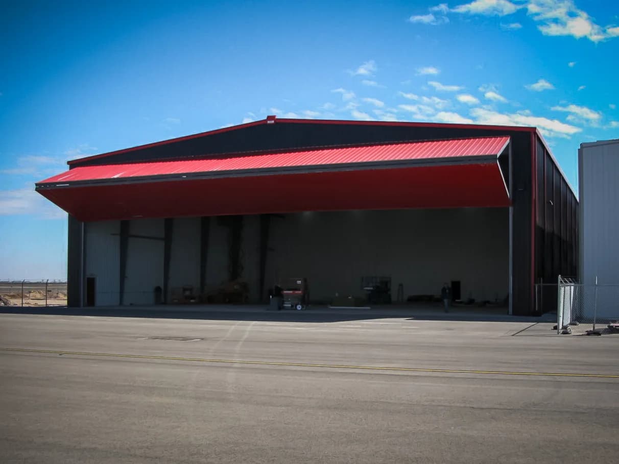 Steel hangar front view with large bifold door fully open
