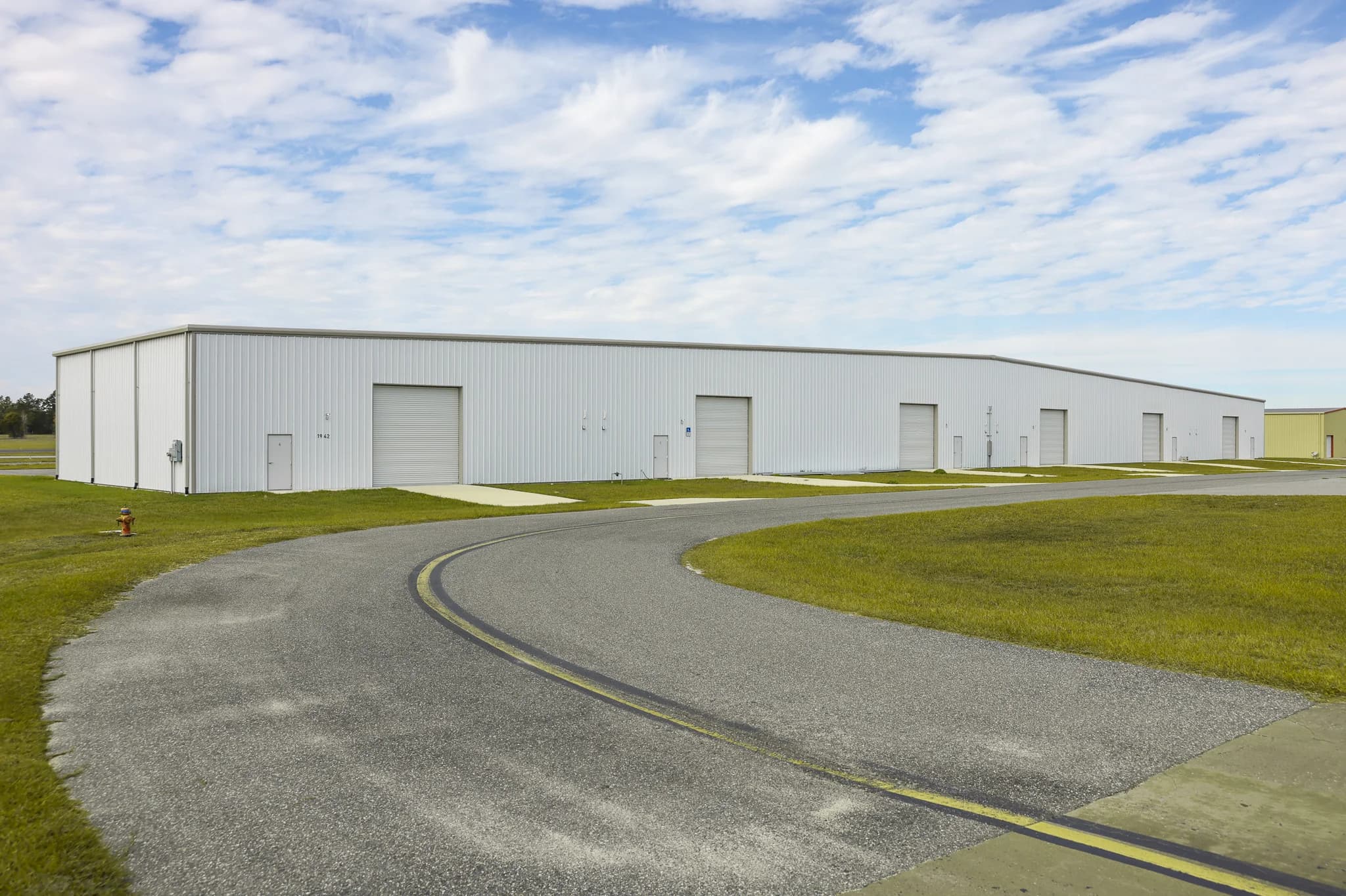 Ocala Airport white multi-bay hangar complex from taxiway
