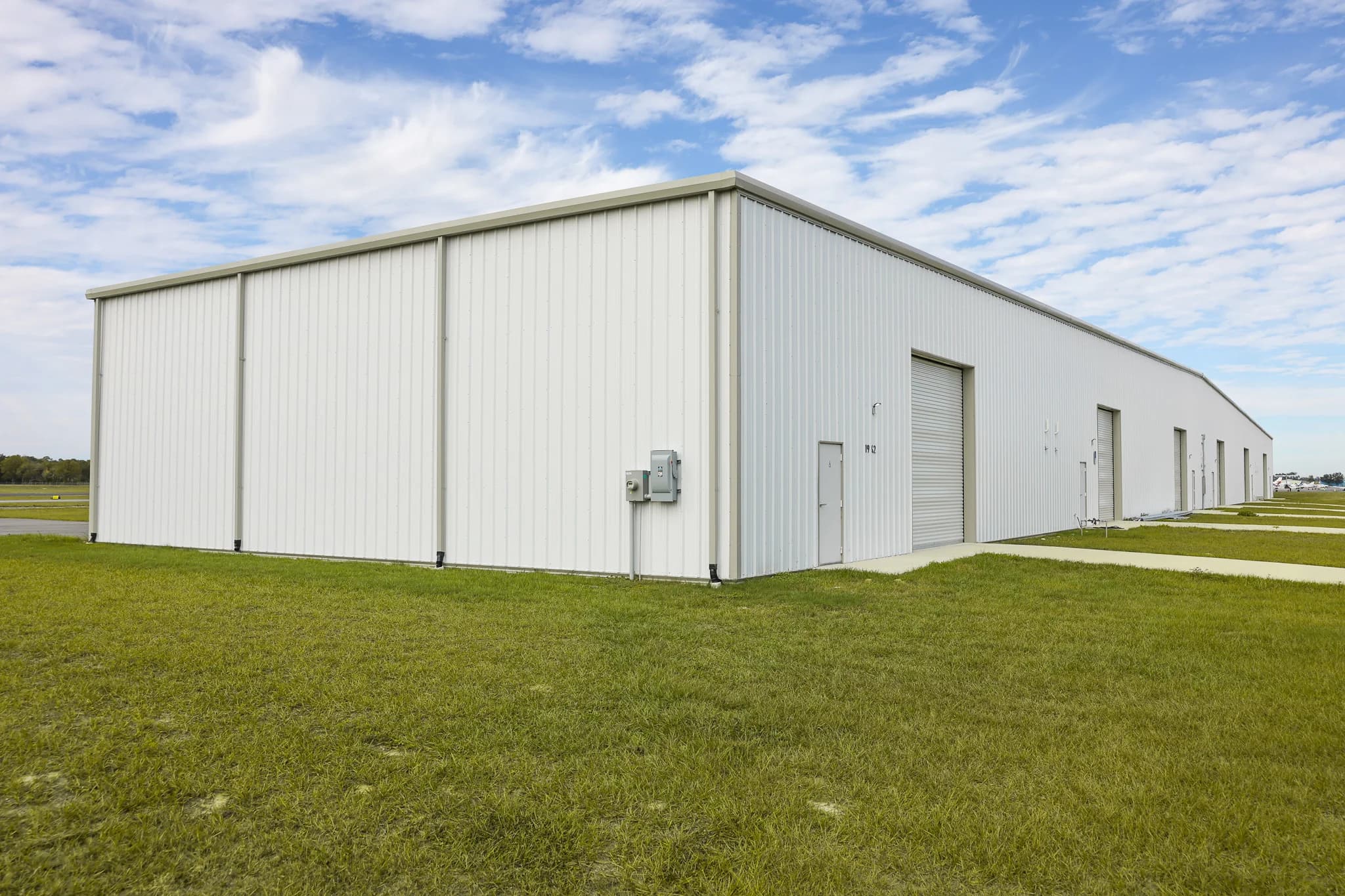 Ocala Airport hangar side view with roll-up doors