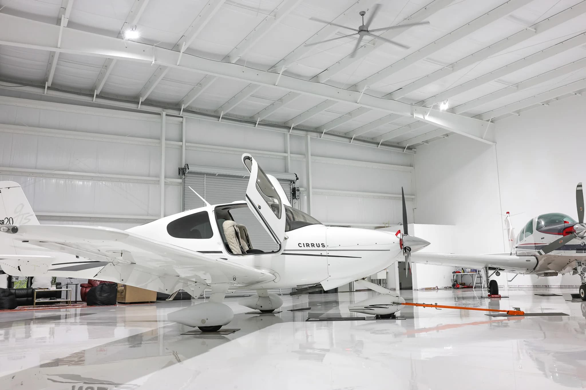 Cirrus SR20 with canopy open inside finished hangar