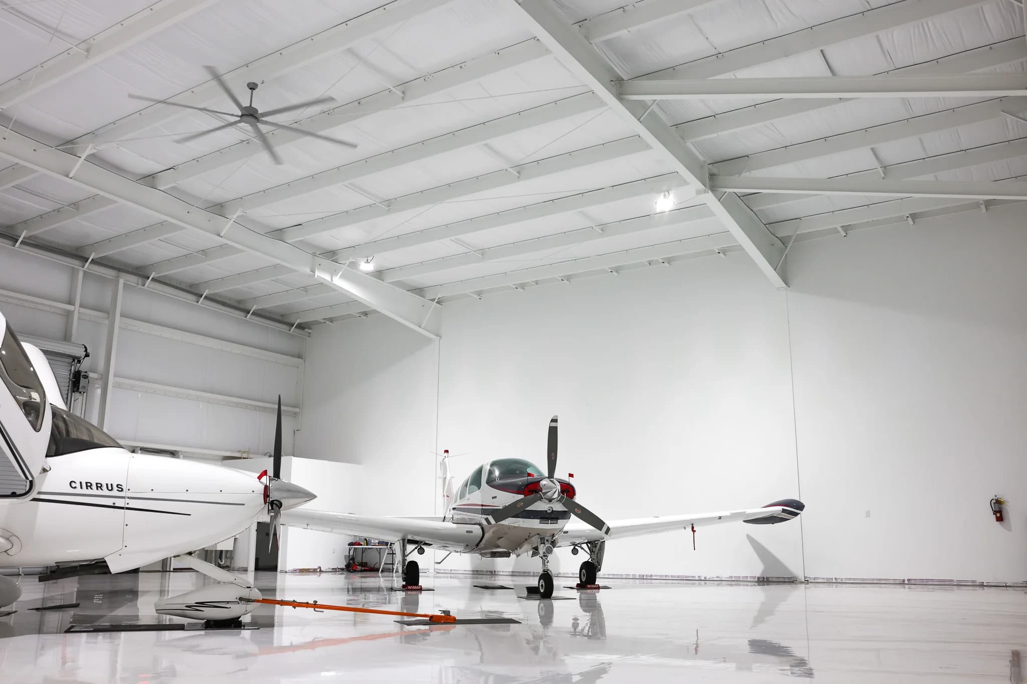 Aircraft in hangar showing insulated ceiling and HVLS fan