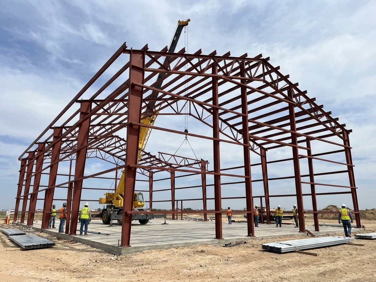 Steel barndominium frame being erected during the rapid framing phase of construction