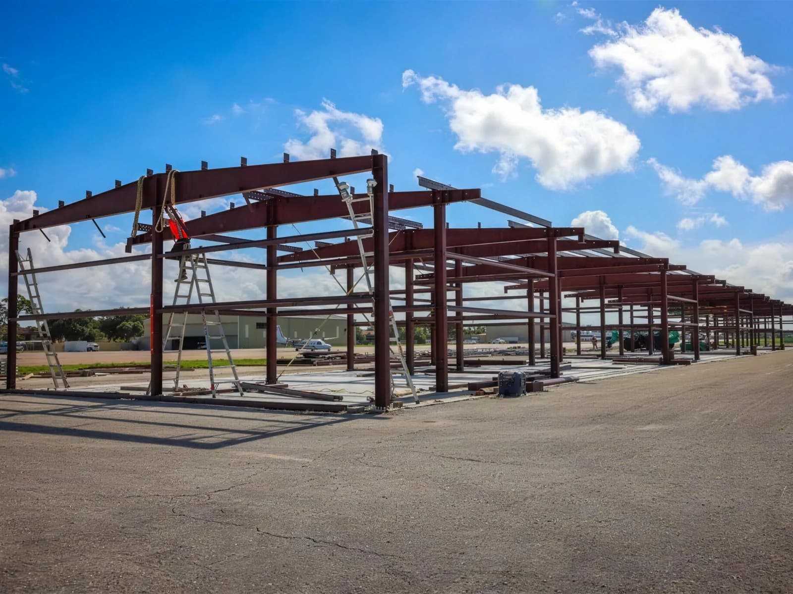Steel building frame standing complete on site, ready for enclosure