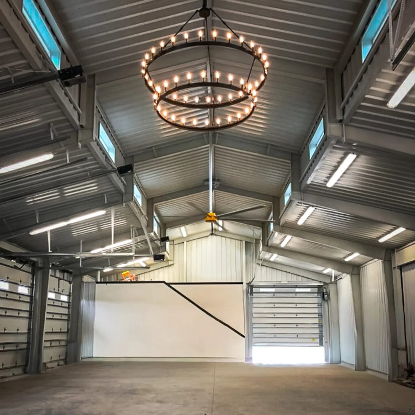 Finished steel building interior with clear-span ceiling and overhead doors