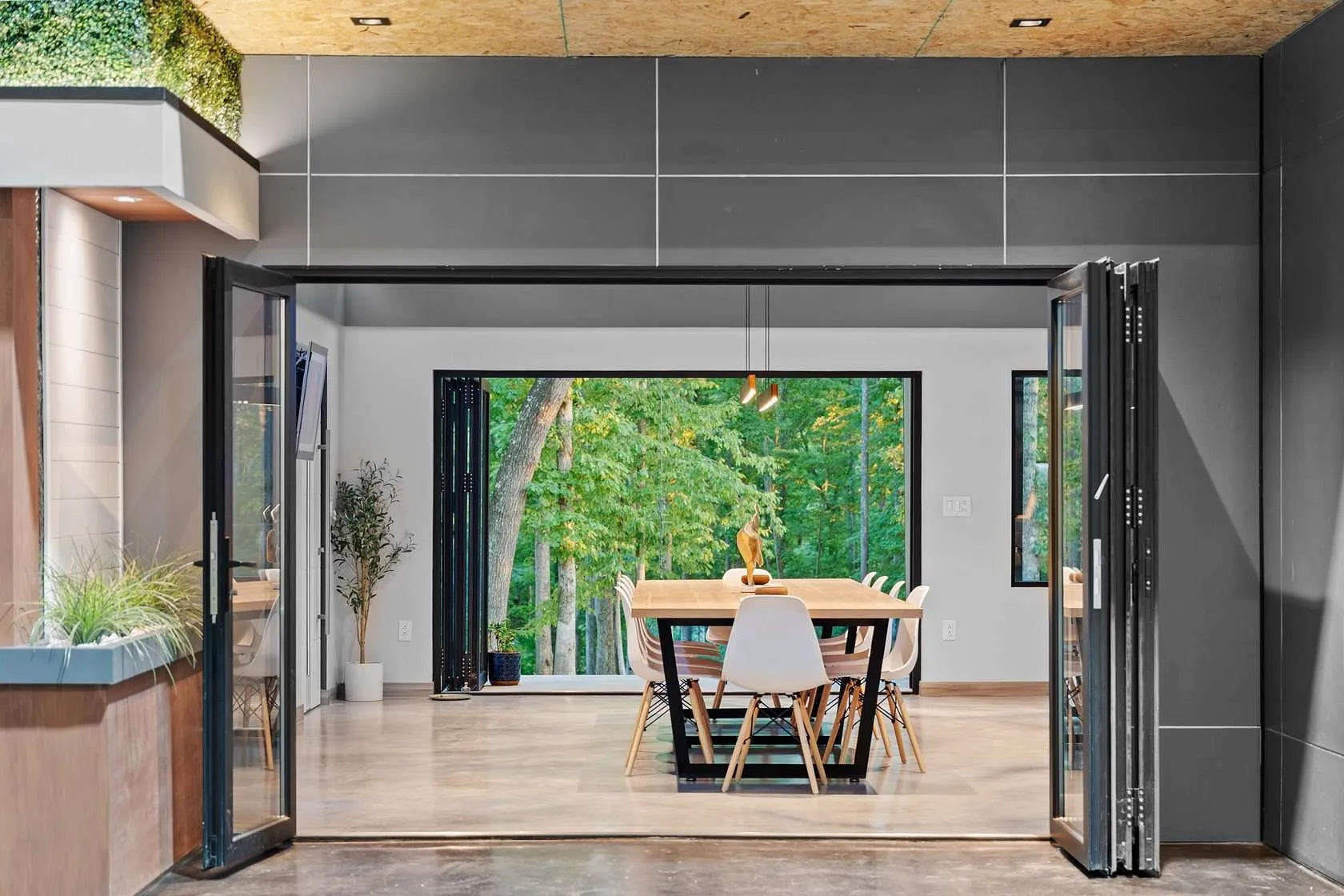 Indoor-outdoor dining area with folding glass doors